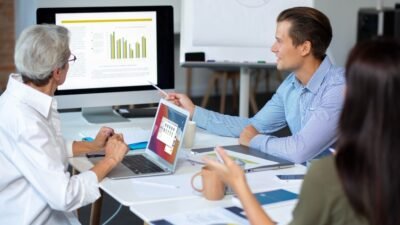 Healthcare market research team analyzing data and charts in a strategy meeting